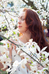 Redhead with green eyes in spring garden