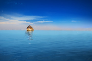 Overwater bungalows with tourquise clear water in tropical island