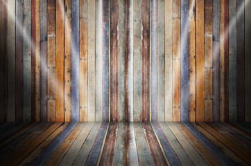 light in dark room with colorful wooden floor and green stage wall