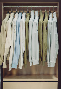 Colorful male jackets in row in a hanger