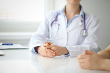 Doctor and patient are discussing something, just hands at the table