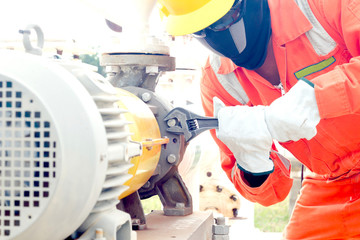 Close-up image of human hand fixing and stop leak of manometer by wrench in oil and gas process