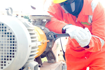 Close-up image of human hand fixing and stop leak of manometer by wrench in oil and gas process