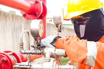 Close-up image of human hand fixing and stop leak of manometer by wrench in oil and gas process