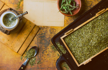 Yerba mate on antique map. Dry herb. Top View. Vintage background