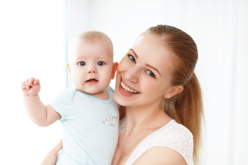 happy family mother playing  with baby