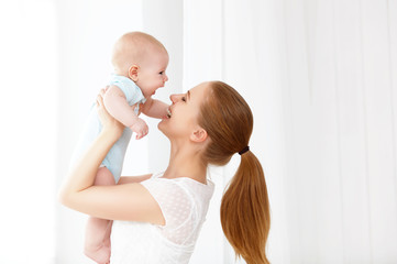 happy family mother playing  with baby