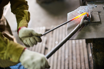 Men's hands in the process of production of metal Handicrafts