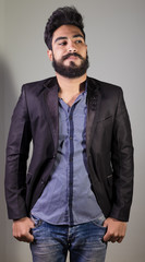 Fototapeta premium Studio shot of Iraq brunette boy fwith thick beard in strange mood