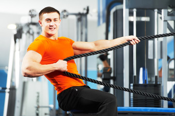 Fototapeta na wymiar bodybuilder man doing exercises in fitness club