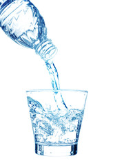Pouring water on a glass on white background