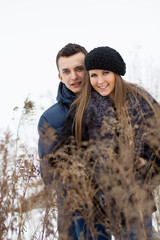 Happy Young Couple in Winter field