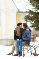 Lovers kissing on the bench