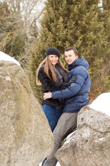 Naklejka premium Happy Young Couple in Winter mountains