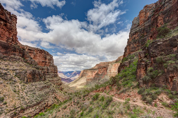 Fototapeta na wymiar AZ-Grand Canyon National Park-S Rim-Bright Angel Trail. Spectacular cloud formations and scenery envelope the hiker!