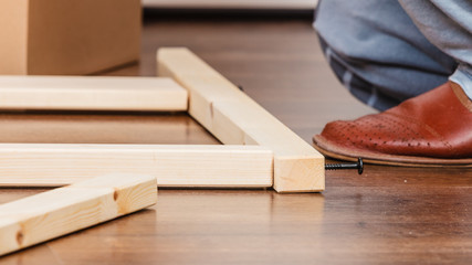 Human assembling wood furniture. DIY.