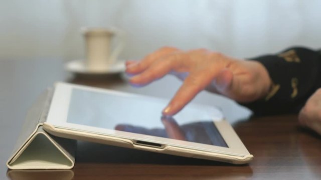 Woman looking at pictures on digital tablet