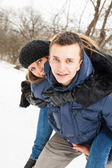 The young family plays winter wood on snow