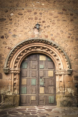 Fototapeta na wymiar ancient wooden door on a stone made wall