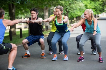 Fitness class doing squat sequence