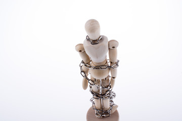 wooden model man in chains