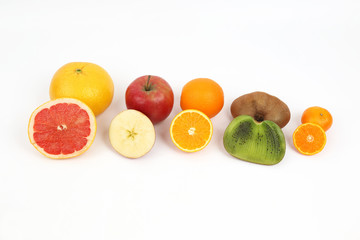 different fruit whole and sliced on white background