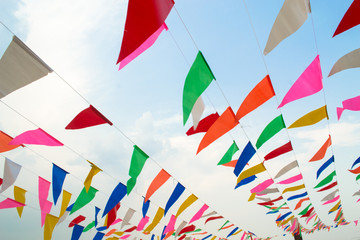 Multi Colored Triangular Flags Hanging in the Sky at an Outdoor