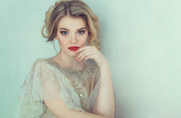 Beautiful bride in wedding dress. Portrait of young bride. Studio shot.
