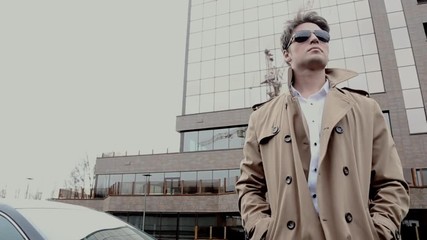 A man in a coat and sunglasses