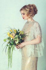 Beautiful bride in wedding dress. Portrait of young bride. Studio shot.
