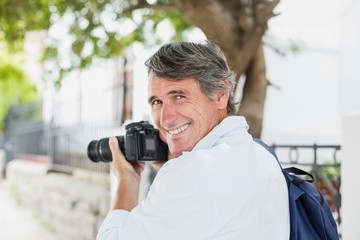 Rear view portrait of man using camera