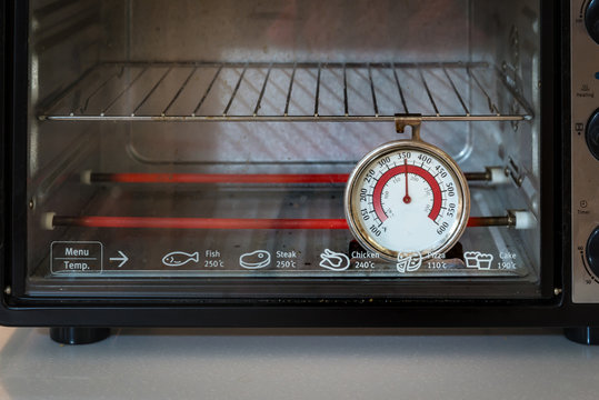 Old oven thermometer in the kitchen at home