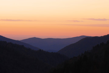 mountain and valley in mist under sunset twilight