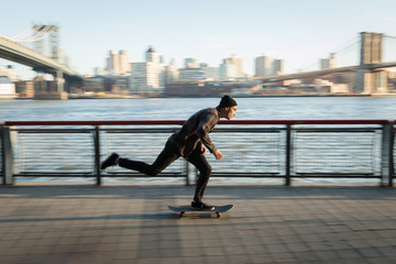 Young skateboarder cruise down on pedestrian walk