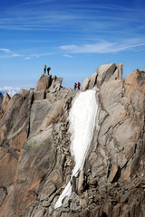 Fototapeta premium The alpinists on top of cliff in French Alps