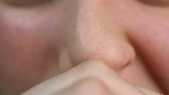 Person having allergy and rubbing nose. Health problems. Close-up view