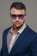 A man in a suit and sunglasses.