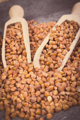 Vintage photo, Buckwheat groats with spoon on cement structure