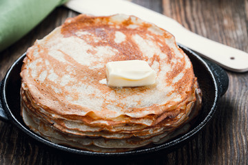  Stack of fresh homemade crepes with butter on top