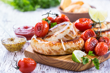 Grilled sausages and tomatoes in rustic style