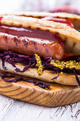 Grilled sausage sandwich with sweet coleslaw and tangy mustard
