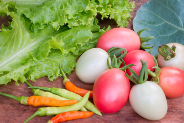 Fresh vegetables, lettuce, tomato, chinese kale and chili on woo