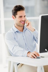 Fototapeta premium Businessman talking on phone