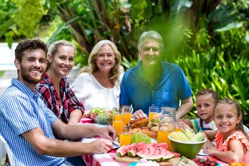 Happy family having lunch in yard 