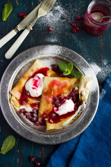 crepe pancakes with cream and pomegranate  sauce