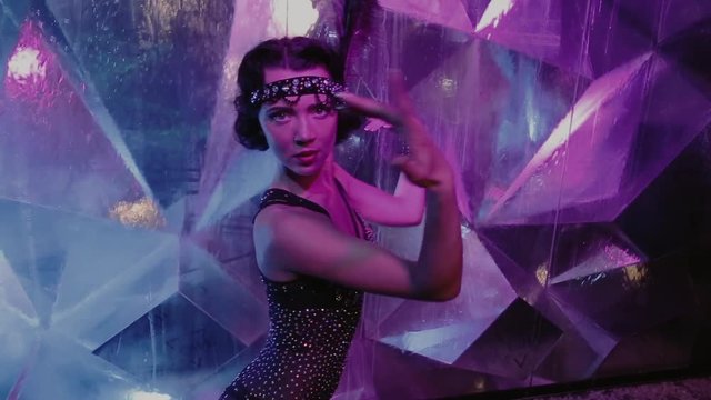 Girl in a burlesque costume dancing on camera