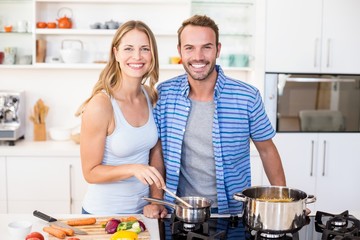 Young couple preparing a meal in kitchen