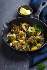 fried artichokes with garlic and lemon on pan