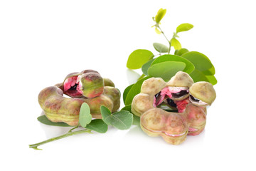 manila tamarind fruit with leaf on white background