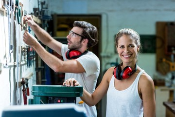 Male and female carpenter working in workshop